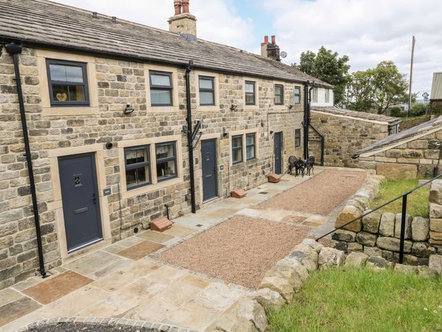 An outdoor area with stone cottage and pathway at Moss Cottage in Cragg Vale