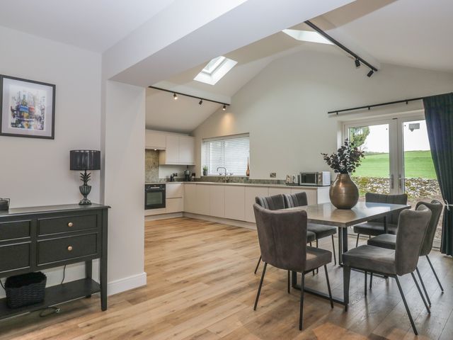 A kitchen with a table and chairs at Cross Winds in Clapham