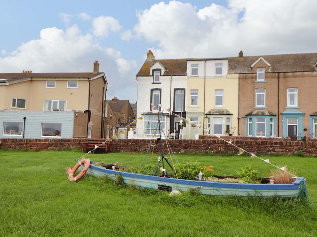 A boat in a garden with houses in the background at 2 The Crescent