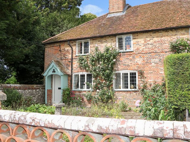 A house with a front door and windows surrounded by plants at 3 Malthouse Cottages Chawton near Alton