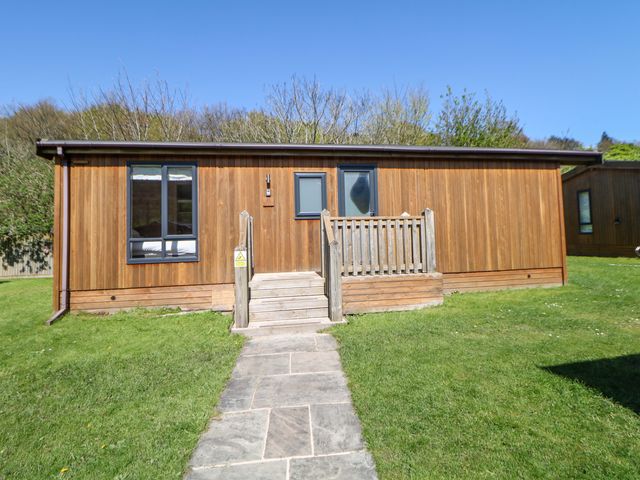 A wooden cabin with steps and a path in front at Dovestone Luxury Lodges (sleeps 6) - pet free, Greenfield
