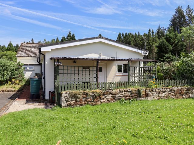 A house with a garage and garden at Fir Tree Cottage near Cottonshopeburnfoot