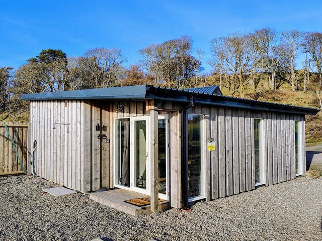 A wooden structure with windows and door at Faodail Studio Kingsburgh near Uig