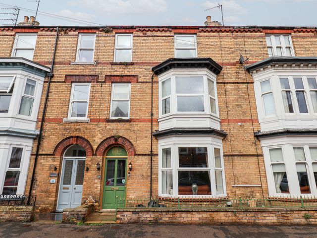 A brick facade with front doors and windows at Rutland Grange in Filey