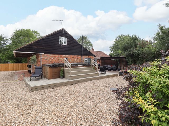 A house with a deck and hot tub in the garden at Wood Farm Cottage Stickney near East Kirkby