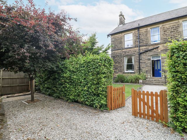 A house exterior with a gravel path and wooden gate at Deeley House Darley Dale