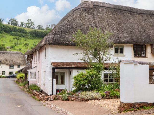 A thatched cottage with garden and pathway at 1 Myrtle Cottages Stokeinteignhead