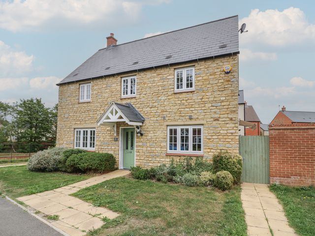 A house with a garden and pathway at Silverstone Paddock Retreat in Silverstone