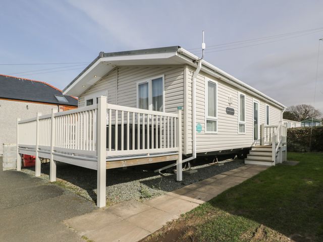 A mobile home with a deck and steps at Gold Lodge (201) Talybont