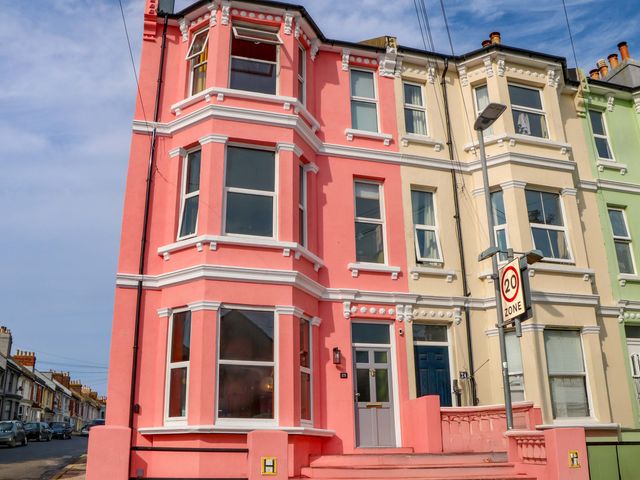 A multi-colored building with windows and a door at Hasting Heights in Hastings