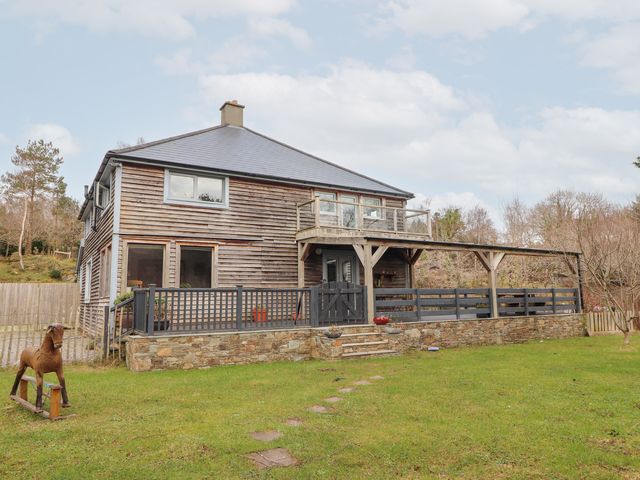 A house with a balcony and garden at Shanti Gher in Bantry