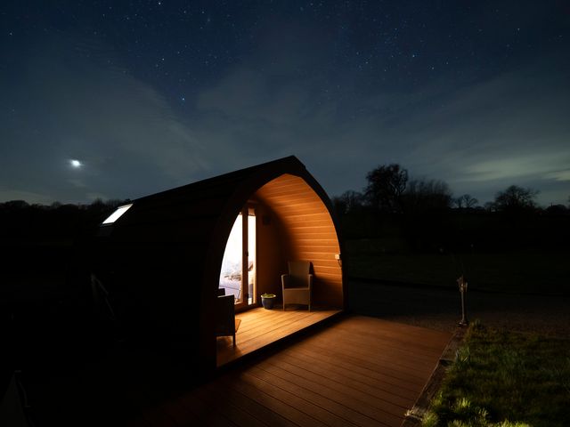 A hut with lighting at night with a view of the stars at Ty Twt Teifi Tregaron