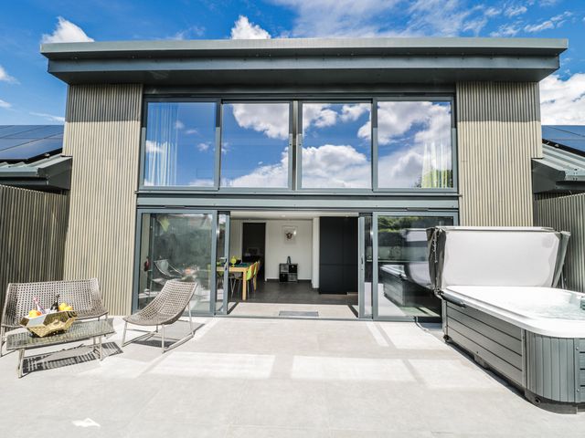 An outdoor area with a hot tub and seating at Number 7 Bishop Sutton