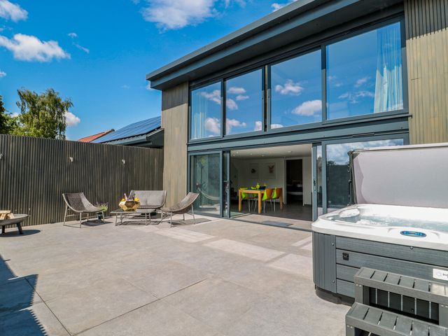 An outdoor area with a spa and seating at Number 7 in Bishop Sutton