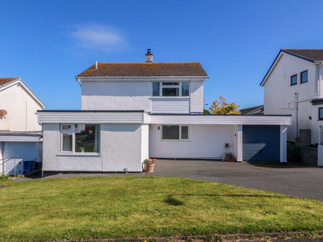A house with a garage and lawn at 20 Gwelfor Estate Cemaes Bay