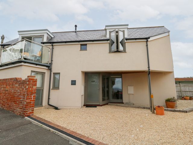 A house with a front door and gravel driveway at Coastguard Lookout in Wyke Regis