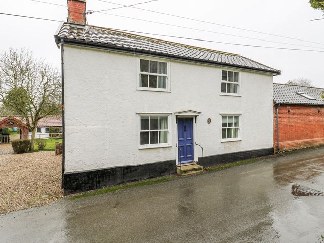 A house with a blue door and windows at White Gates in Banham