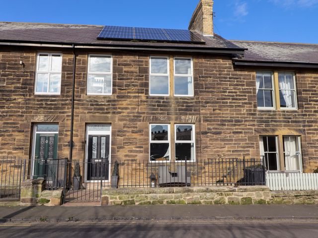 A facade of a building with windows and doors at Dinguardi in Seahouses