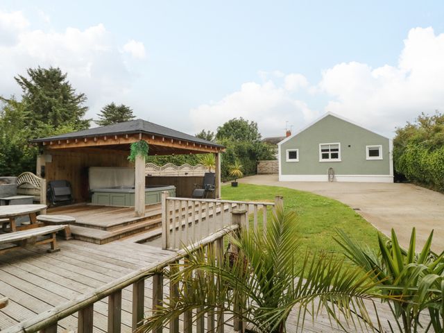 A garden with a gazebo and green house at Woodside Guest House Castlerock