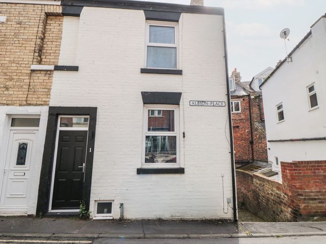 A building exterior with a door and window at 1 Albion Place in Whitby