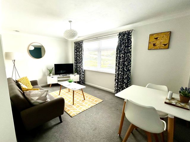 A living room with a sofa and television at 1 Chatsworth Riverscape Apartments in Newquay