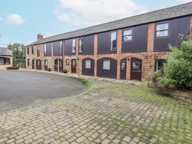 A building with multiple windows and doors at The Coach House near Wigton