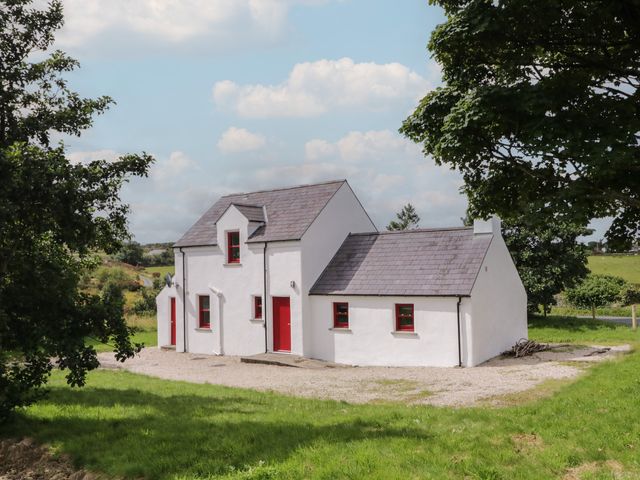 A house with red accents and a gravel area at Shane's Cottage, Falcarragh, County Donegal