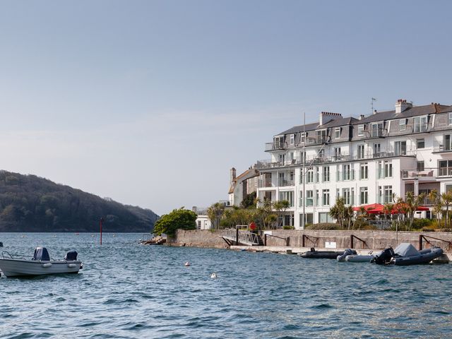 A view of a waterfront building with boats at the dock at 43 The Salcombe in Salcombe