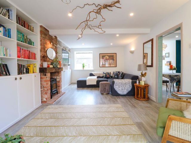 A living room with a fireplace and bookshelves at 83 Meeting Street in Quorn