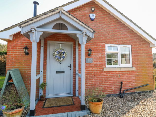 An entrance to a cottage with a door and decorative elements at Frog Leap in Scunthorpe