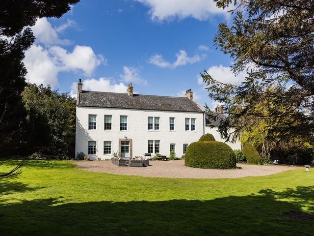 A house with a garden and trees at Cheviot Manor in Akeld near Wooler