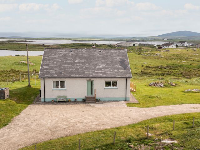 A house with a gravel driveway at Taigh Eva near Lochmaddy