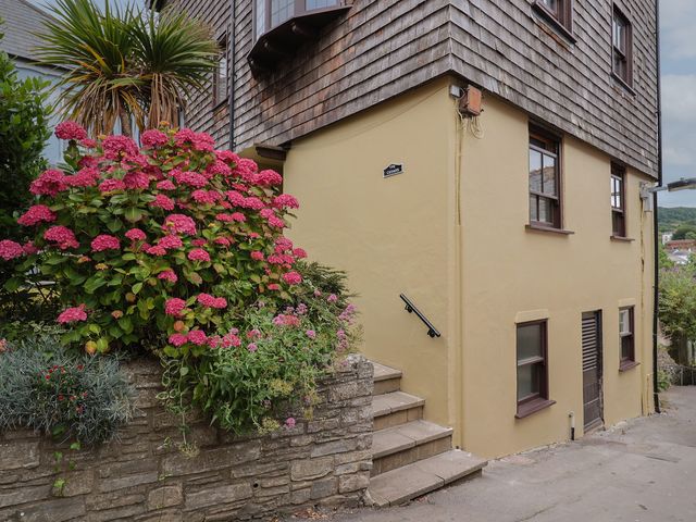 A house exterior with flowering plants and steps at Flat 2 The Cedars in Lyme Regis