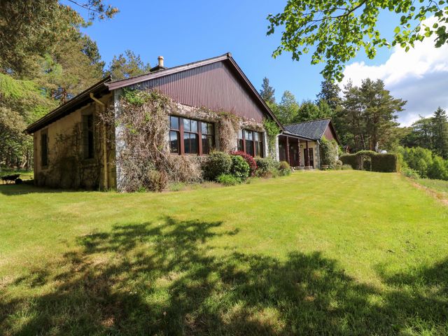 A house with windows and doors on a grassy area at Creag Bhalg near Mar Lodge