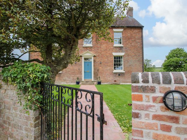 A house with a blue door and garden at Highfields Farm Church Preen near Much Wenlock