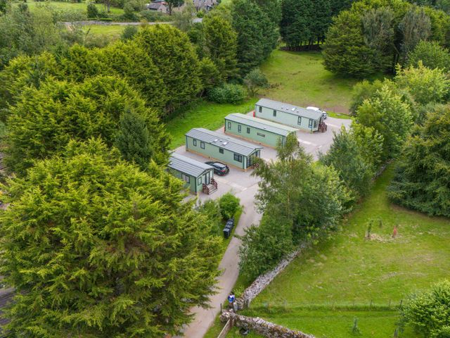 An outdoor area with cabins and trees at Lodge 4 in Silverdale