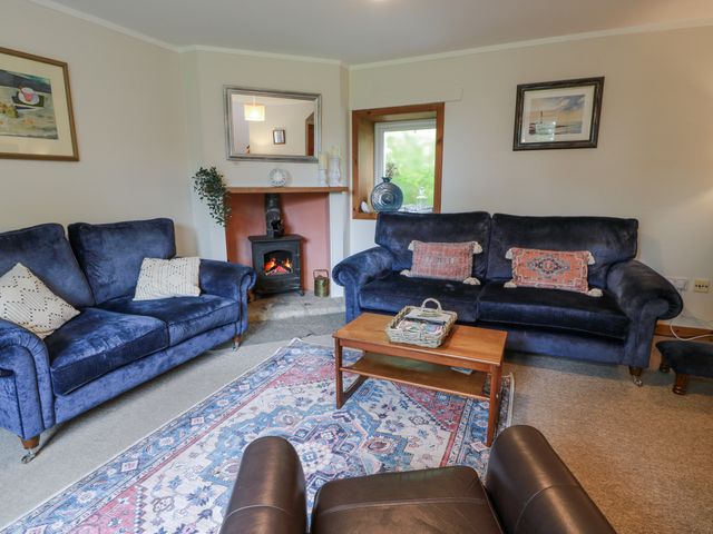 A living room with sofas and a fireplace at The Steading in Castle Douglas