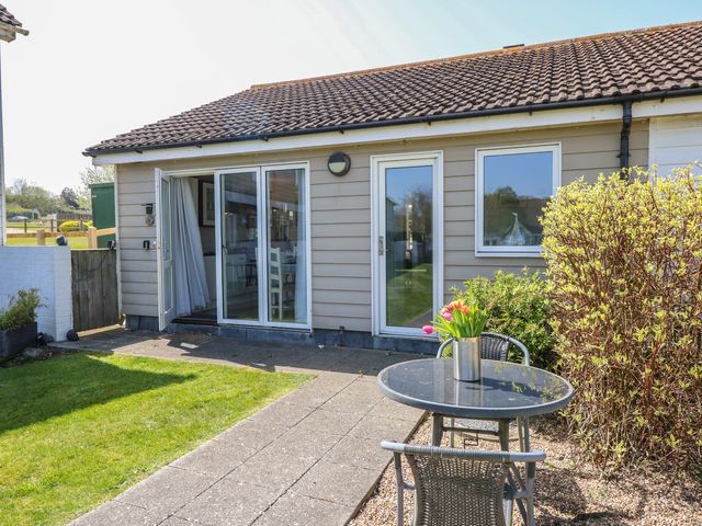 An outdoor area with a table and chairs at Plimoth N8 in Yarmouth