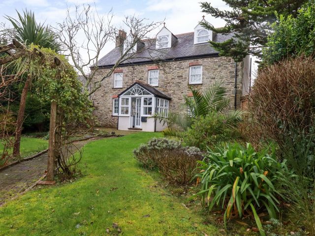 A house with a garden and pathway at Vosporth Villa in Newquay
