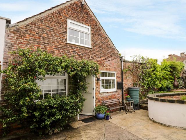 A house with a green shrub near the door at Figgy Cottage Ripon