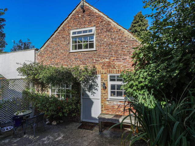 An outdoor area with brick exterior and seating at Figgy Cottage in Ripon