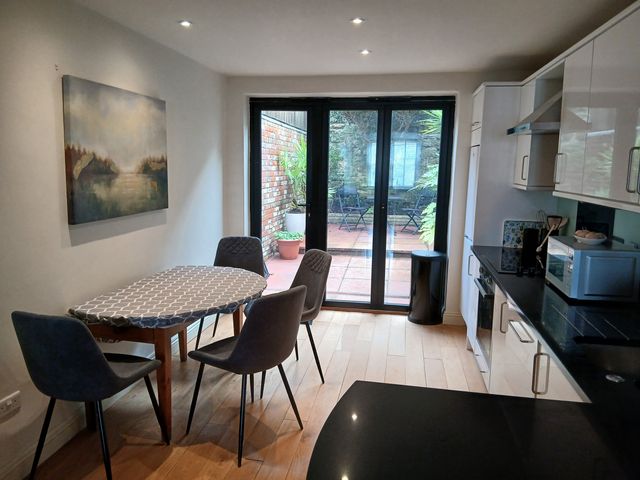 A kitchen with a table and chairs at Harbourside in Weymouth