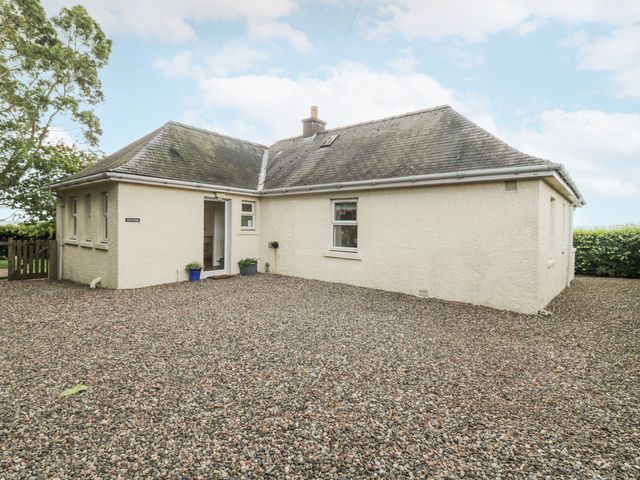 A house exterior with gravel driveway and planter at Top Cottage in Cupar, Fife