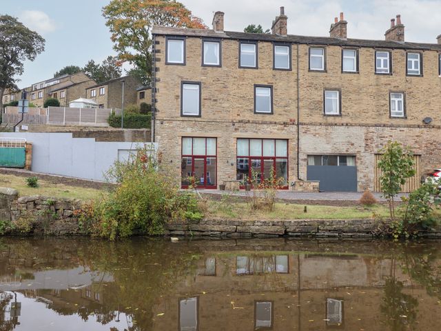 A building with windows by a canal at Canal Side in Skipton