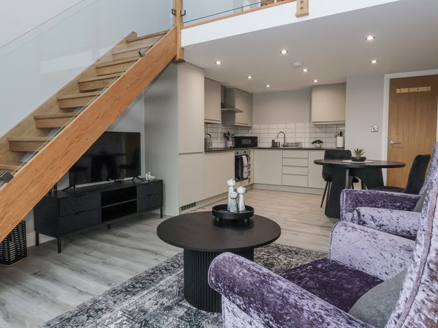A living room with a kitchenette and seating area at Waters Edge in Skipton