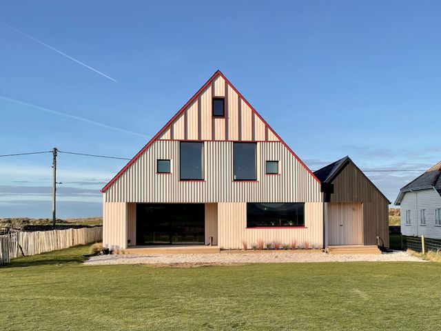 A house with large windows and a door at Twyn Isaf in Borth