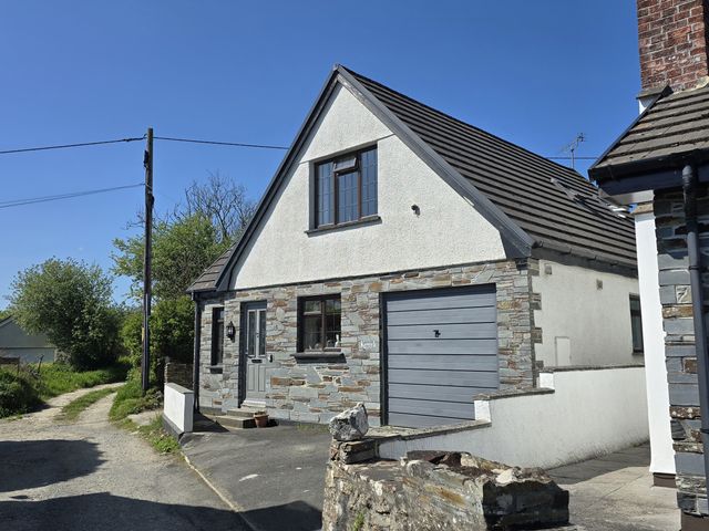 A house with a garage and pathway at Kernyk in Camelford