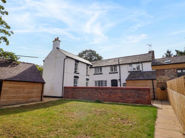 An outdoor view of a house with garden area at The Farmhouse in Oswestry