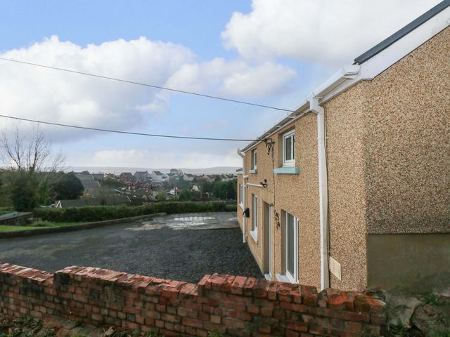 A house with a driveway and a view of the neighborhood at Graig Goch Burry Port