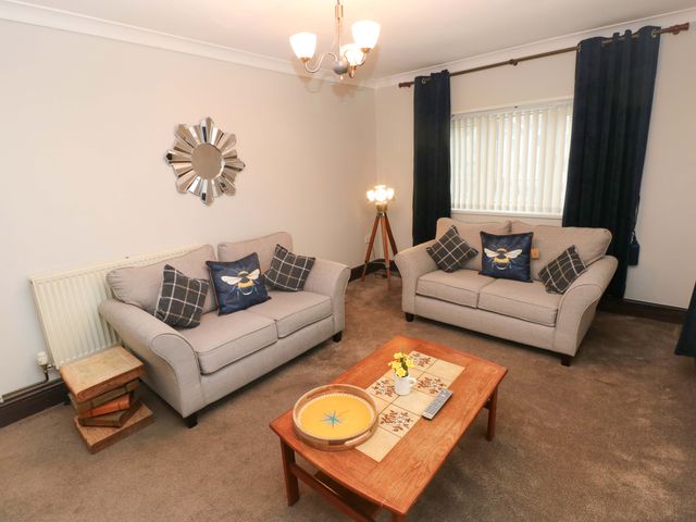 A living room with two couches and a coffee table at Graig Goch Burry Port